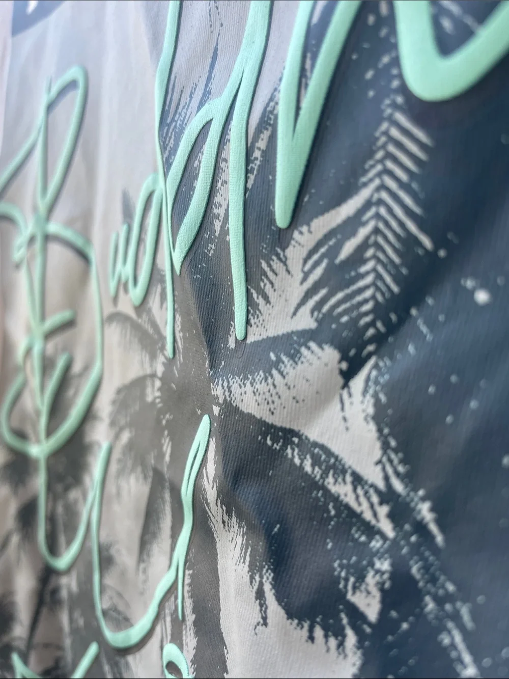 True Religion White Tee with Mint Green Raised Script and Palm Trees Graphic.